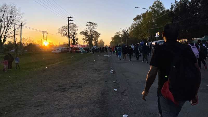 Pilgrims walk as the sun sets