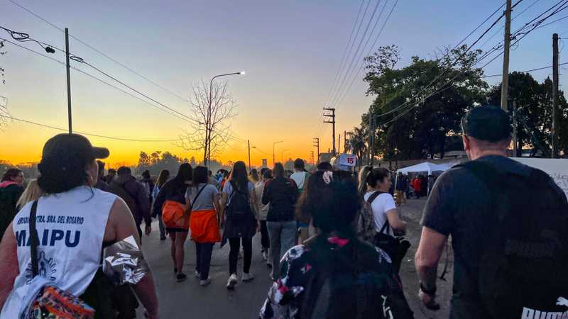 Pilgrims walk eastwards, towards the town of Luján, under the setting Argentine sun