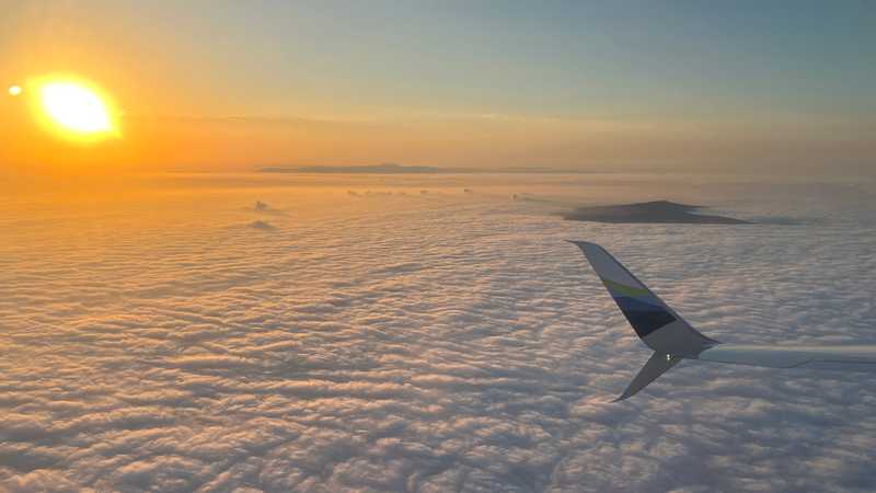Catalina Island and the Palos Verdes peninsula peek over the clouds as the sun rises over Southern California